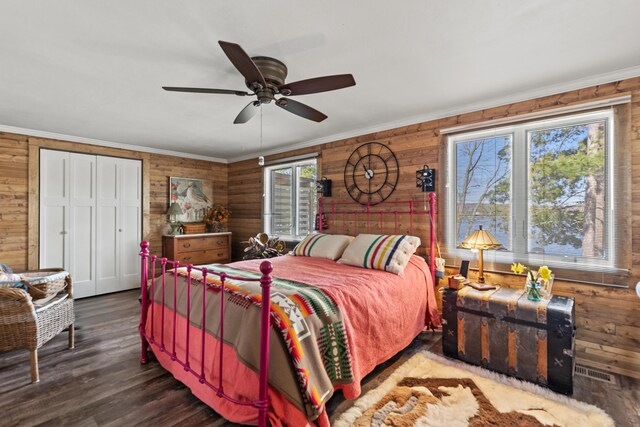 3509 N Shore Dr, Sears, MI 49679 - bedroom with wooden walls, crown molding, ceiling fan, and wood finished floors