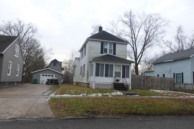 front of property with a garage and an outbuilding