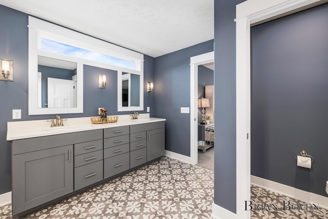 bathroom featuring vanity, a wealth of natural light, and a textured ceiling