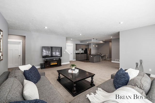 carpeted living room with a textured ceiling