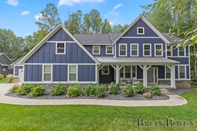 view of front of property with covered porch and a front lawn