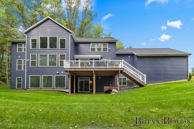 rear view of property with a deck and a lawn