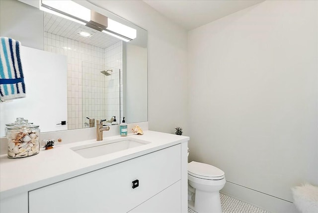 bathroom featuring a shower, vanity, and toilet