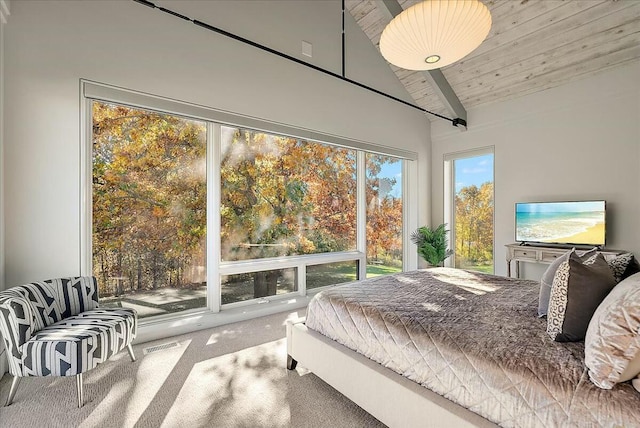 bedroom with carpet flooring, vaulted ceiling, and wooden ceiling