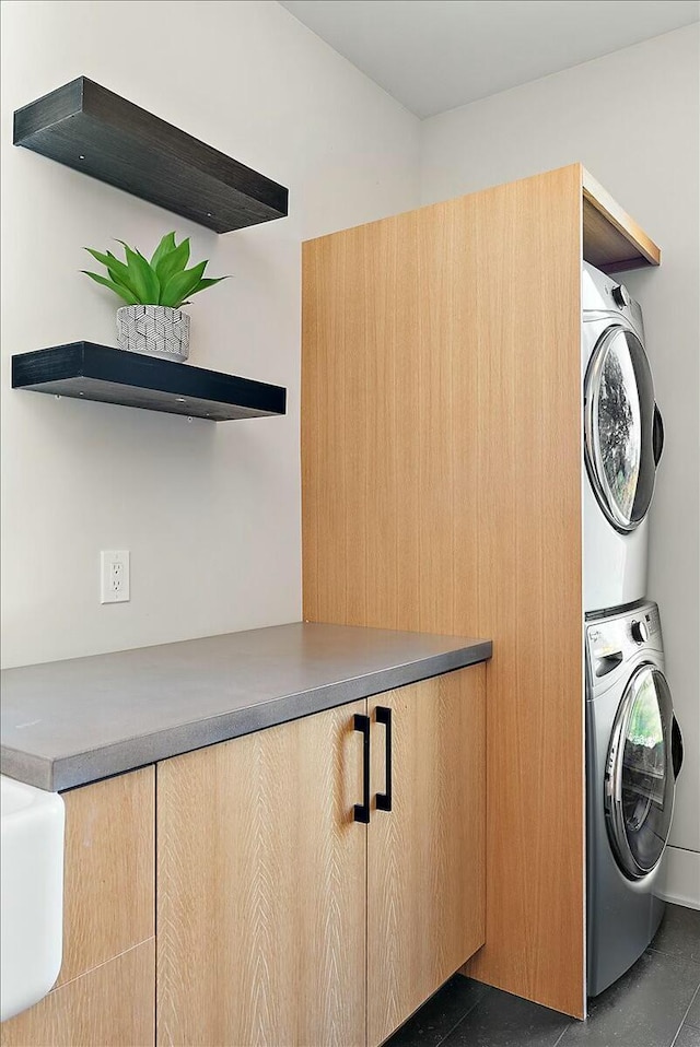 laundry area with stacked washer and dryer