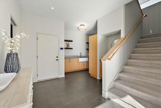 entrance foyer with dark hardwood / wood-style floors and sink