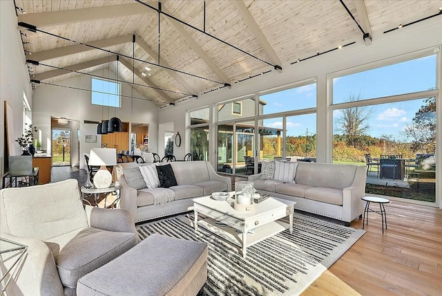 living room featuring high vaulted ceiling, hardwood / wood-style floors, wooden ceiling, and beam ceiling