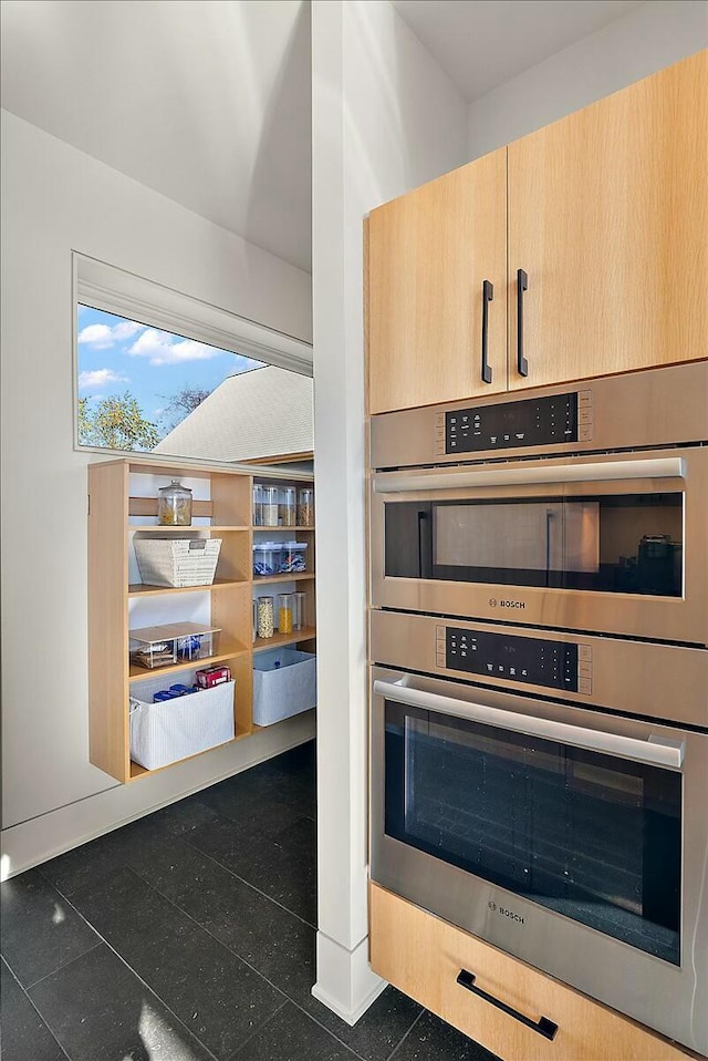 kitchen featuring light brown cabinets and stainless steel double oven