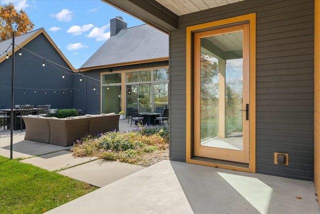 doorway to property with an outdoor living space and a patio area