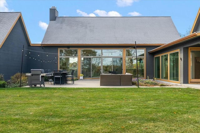 back of house with a yard, an outdoor living space, and a patio area