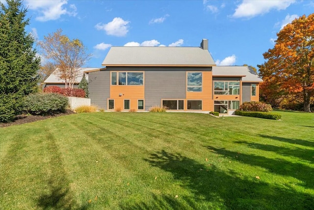 back of house featuring a yard