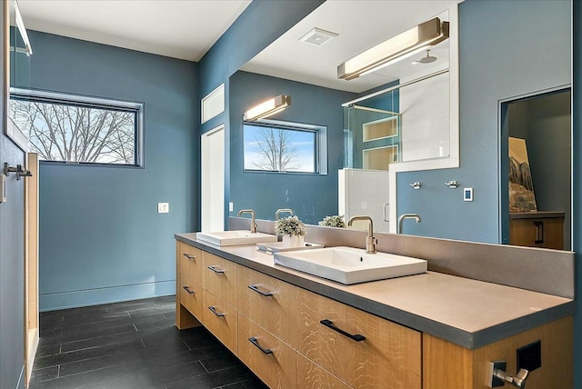 bathroom with a healthy amount of sunlight, wood-type flooring, and vanity