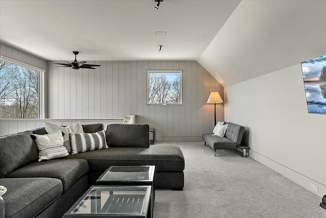 carpeted living room with lofted ceiling, ceiling fan, and a healthy amount of sunlight