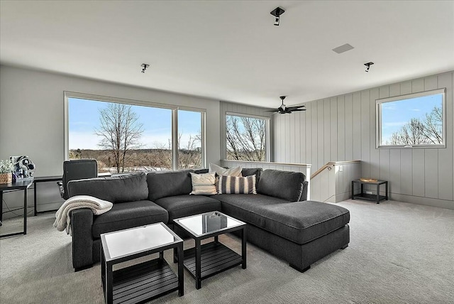 living room featuring a wealth of natural light and light colored carpet