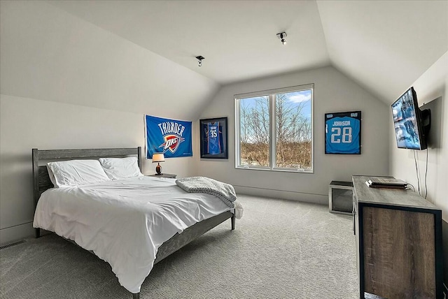 bedroom featuring light carpet and vaulted ceiling