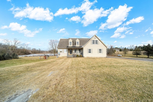 rear view of property featuring a lawn