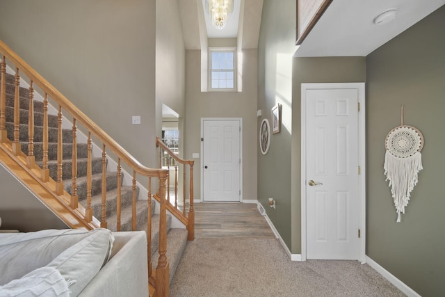 carpeted foyer with a high ceiling