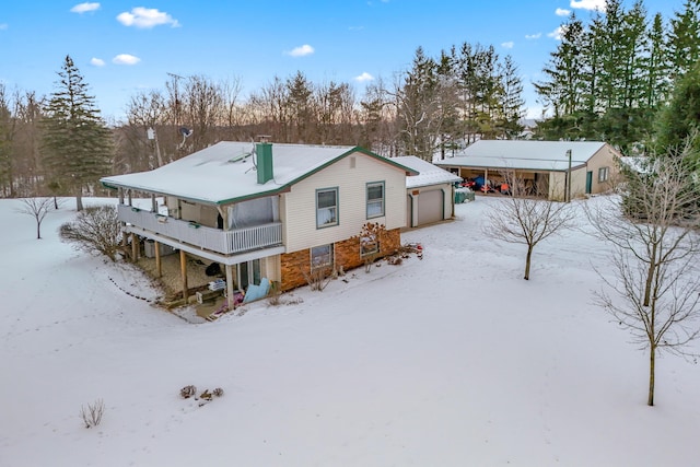 snow covered property featuring a garage