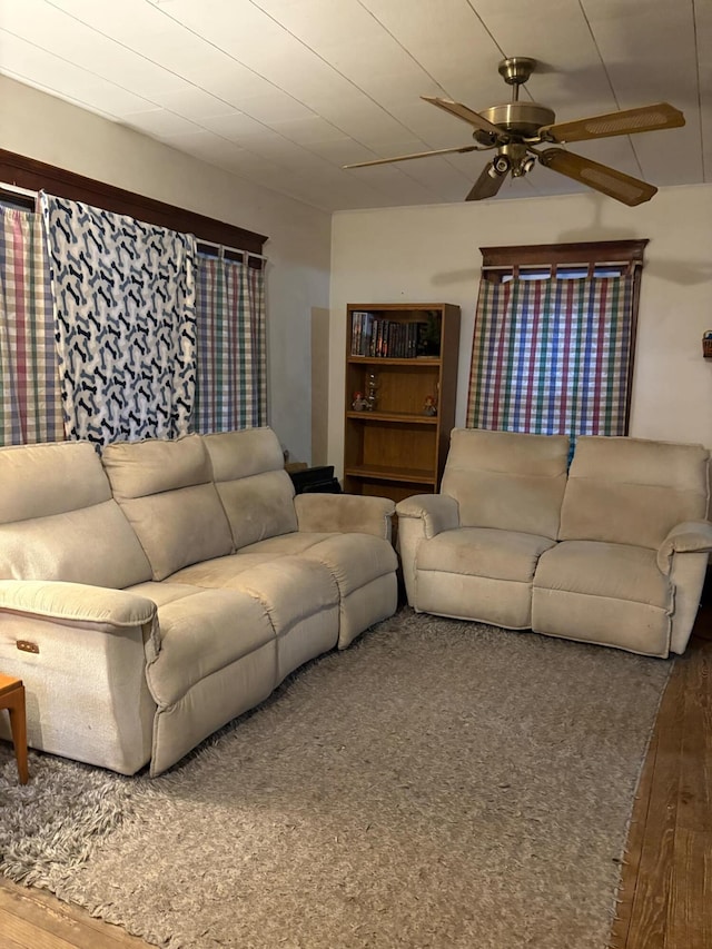 living room featuring hardwood / wood-style floors and ceiling fan