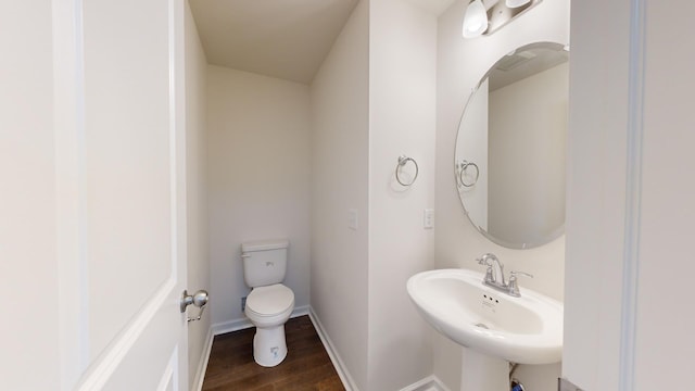 bathroom featuring hardwood / wood-style flooring, sink, and toilet