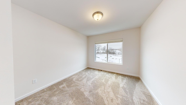 empty room featuring light colored carpet