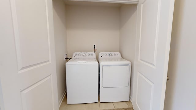 washroom featuring washing machine and dryer and light tile patterned flooring