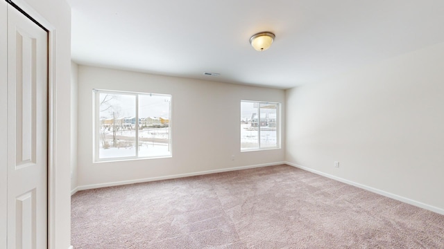 spare room featuring light colored carpet