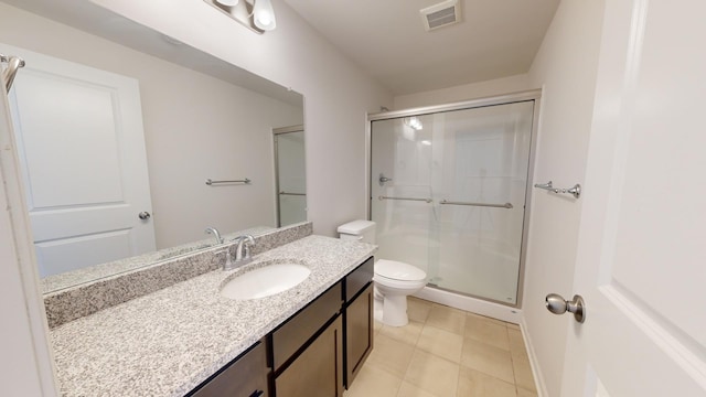 bathroom featuring vanity, tile patterned floors, toilet, and walk in shower