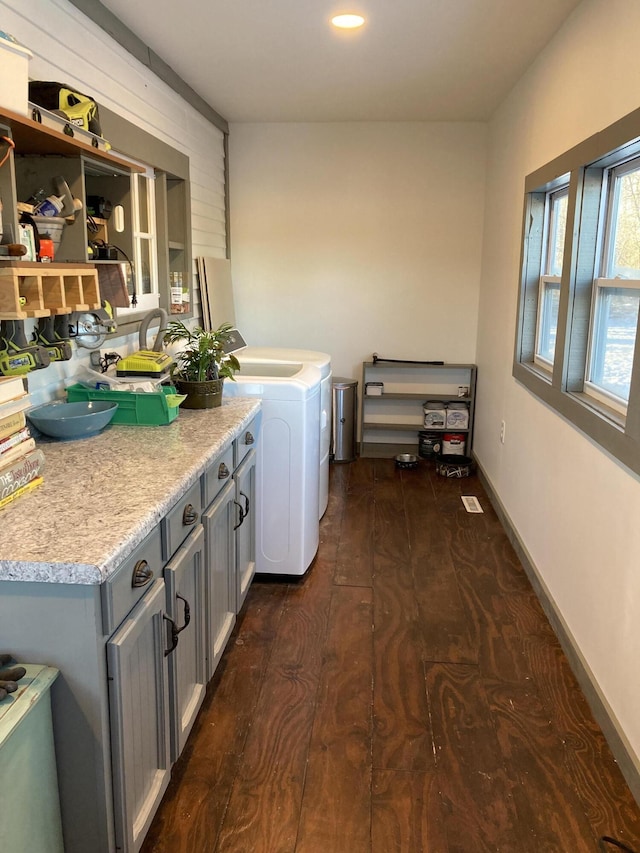 clothes washing area featuring separate washer and dryer and dark hardwood / wood-style floors