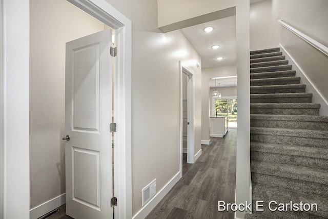 staircase featuring wood-type flooring and sink