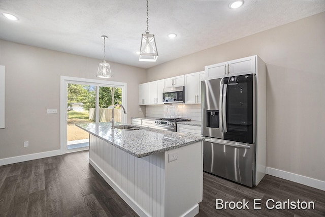 kitchen featuring sink, a center island with sink, white cabinets, and appliances with stainless steel finishes