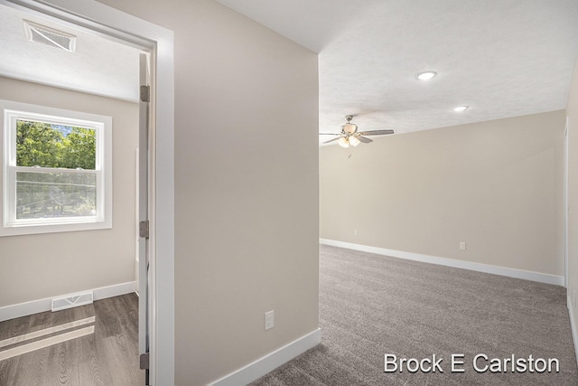 unfurnished room with ceiling fan and wood-type flooring