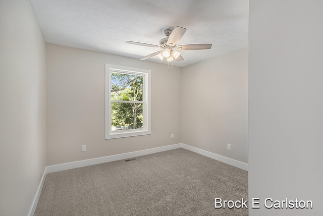 carpeted spare room with ceiling fan