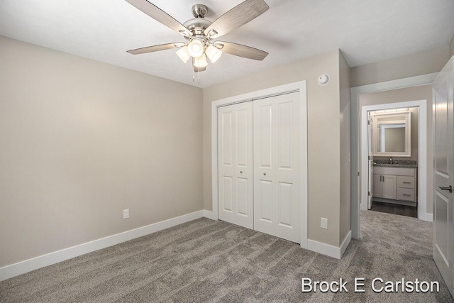 unfurnished bedroom with ceiling fan, carpet flooring, sink, and a closet