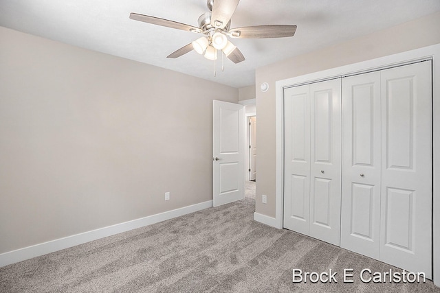 unfurnished bedroom featuring light carpet, a closet, and ceiling fan