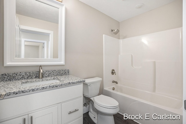 full bathroom featuring vanity, wood-type flooring,  shower combination, and toilet