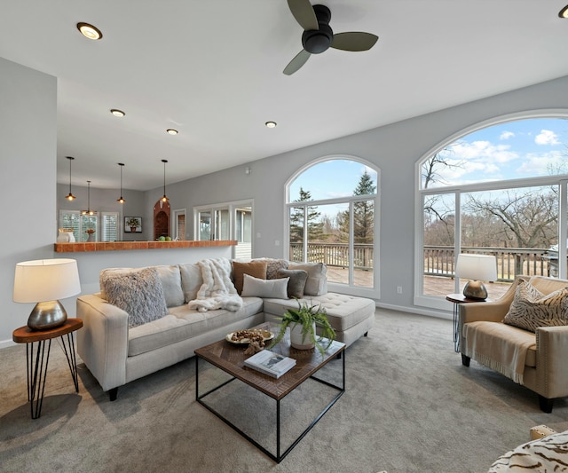 carpeted living room featuring ceiling fan