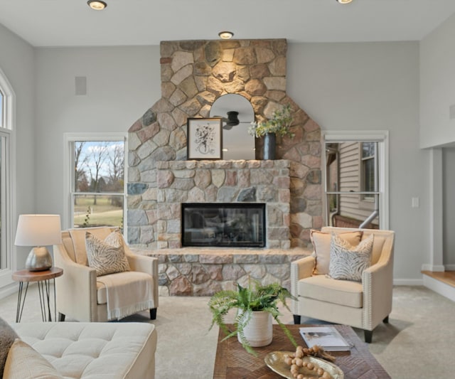 carpeted living room featuring a fireplace