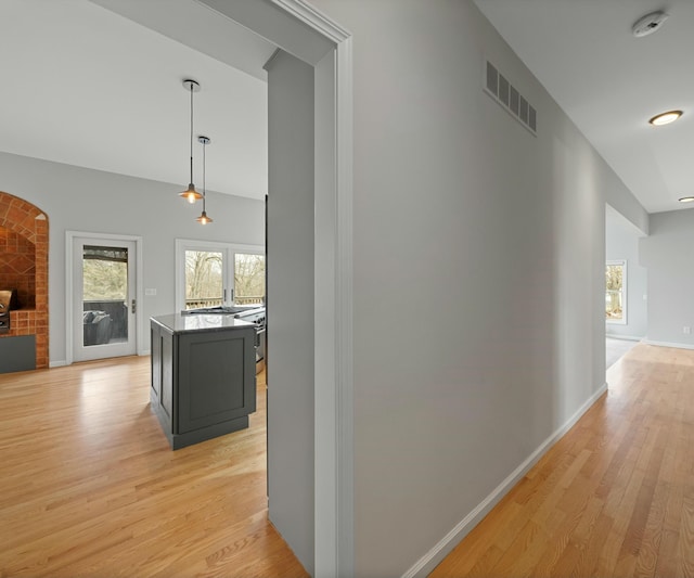 hallway with light hardwood / wood-style flooring