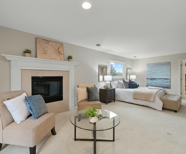 bedroom with a tile fireplace and carpet floors