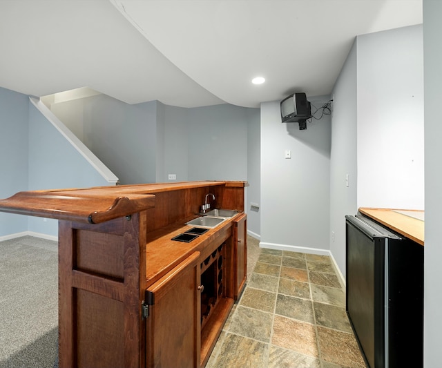 bar featuring fridge and sink