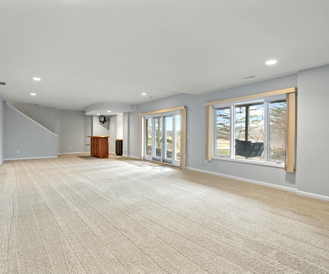 unfurnished living room with light colored carpet