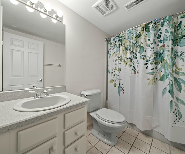 bathroom featuring tile patterned floors, toilet, and vanity