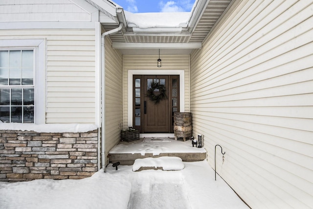 view of snow covered property entrance