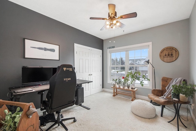 carpeted office space featuring ceiling fan