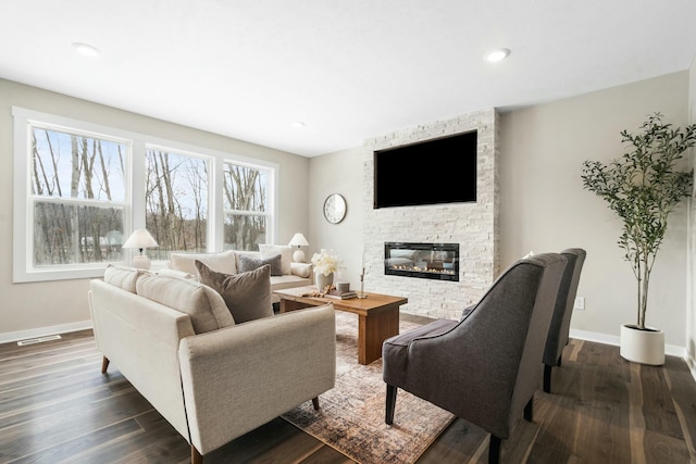 living room with a fireplace and dark hardwood / wood-style floors