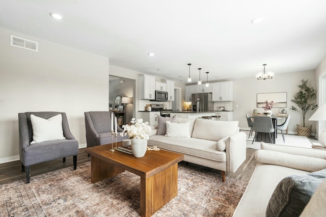 living room featuring hardwood / wood-style floors and a chandelier