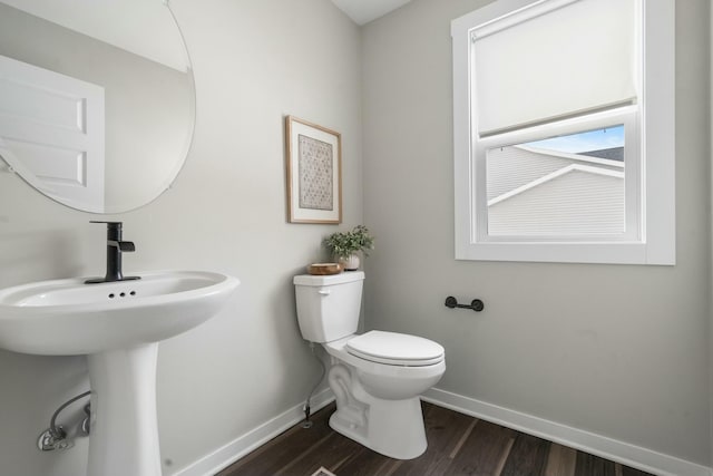 bathroom featuring hardwood / wood-style floors and toilet