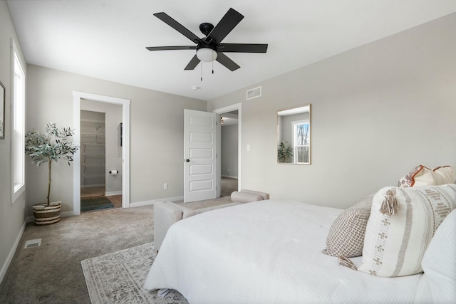 bedroom featuring ceiling fan, connected bathroom, and carpet floors