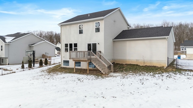 snow covered property featuring a deck